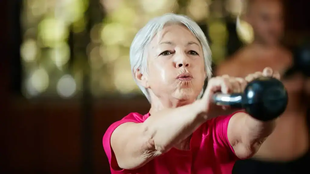 Toning Arms After 60: Empowering Womens Fitness Through Effective Weight Training 1 Older woman doing weight training Rotherham to help her strength and longevity